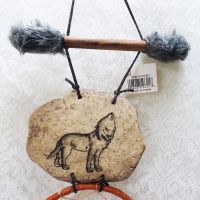 Dream Catcher with image of a howling wolf imprinted on a rock hanging from a stick and two webbed hoops. Feathers and beads: Rock and Stick Catcher View - Click to enlarge