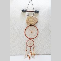 Dream Catcher with image of a howling wolf imprinted on a rock hanging from a stick and two webbed hoops. Feathers and beads: Back View - Click to enlarge