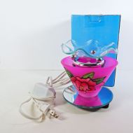 Electric scented oil tart warmer featuring a raised etched rose design against a deep pink background: With Box View