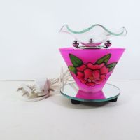 Electric scented oil tart warmer featuring a raised etched rose design against a deep pink background: Front View - Click to enlarge