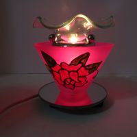 Electric scented oil tart warmer featuring a raised etched rose design against a deep pink background: Front On View - Click to enlarge