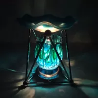 Electric oil warmer with melting blue colors on a triangular metal frame. Frostie blue dish. Nightlight: Turned On - Click to enlarge