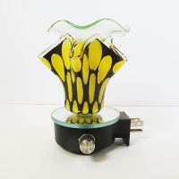 Plugin electric scented oil wax tart warmer featuring yellow ovals on a black background with a ruffle like design: Front View - Click to enlarge