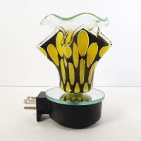 Plugin electric scented oil wax tart warmer featuring yellow ovals on a black background with a ruffle like design: Left Side View - Click to enlarge