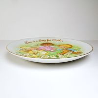 1983 Mother's Day Avon collector plate titled Love is a Song showing three children frolicking in a field of flowers: Side View - Click to enlarge