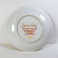 1983 Mother's Day Avon collector plate titled Love is a Song showing three children frolicking in a field of flowers: Bottom View - Click to enlarge