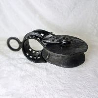 Vintage wood pulley with 5-1/2 inch wood wheel and metal cast iron case or frame with swivel eye. All painted black: Flat Left View - Click to enlarge