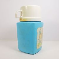 1975 Precious Moments 8 oz. thermos with blue plastic body and cream colored top that doubles as a cup: Right Side View - Click to enlarge