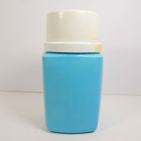 1975 Precious Moments 8 oz. thermos with blue plastic body and cream colored top that doubles as a cup: Left Side View - Click to enlarge