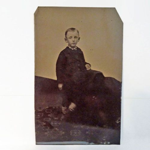 Antique Tintype Photo: Boy with his feet crossed wearing striped socks, standing on a flowered rug: Front View