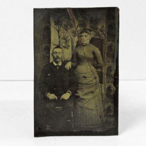 Antique Tintype Photo: man sitting and a woman standing at his side with her hand on his shoulder: Front View