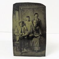 Antique Tintype Photo: Family of four portrait. Two adults sitting in front, a boy and girl standing behind them: Front View - Click to enlarge