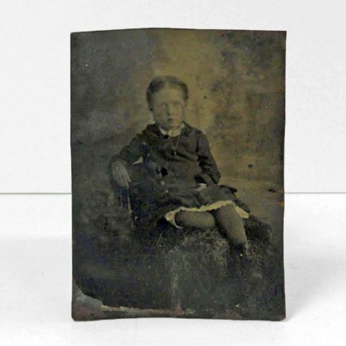 Antique Tintype Photo: Little girl with crossed legs leaning back in a chair: Front View