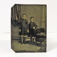 Antique Tintype Photo: Two girls, wearing matching socks, standing holding hands: Front View