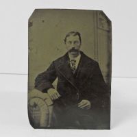 Antique Tintype Photo: Man sporting a mustache that looks like a hairy caterpillar. Heavy coat and argyle tie: Front View - Click to enlarge