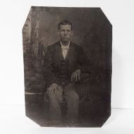 Antique Tintype Photo: Man wearing a button down vest with jacket sitting hand on leg with his fingers spread apart: Front View