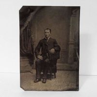 Antique Tintype Photo: Man sitting, wearing a jacket with one button fastened. No hat: Front View - Click to enlarge