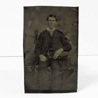 Antique Tintype Photo: Man sitting, wearing a watch chain and jacket with the top button fastened: Front View - Click to enlarge