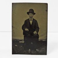 Antique Tintype Photo: Man sitting, wearing a button down vest with jacket and a big hat: Front View - Click to enlarge
