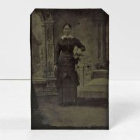 Antique Tintype Photo: Woman arm on a highback button chair wearing a tight fitting long sleeve dress with wide collar and bow: Front View - Click to enlarge